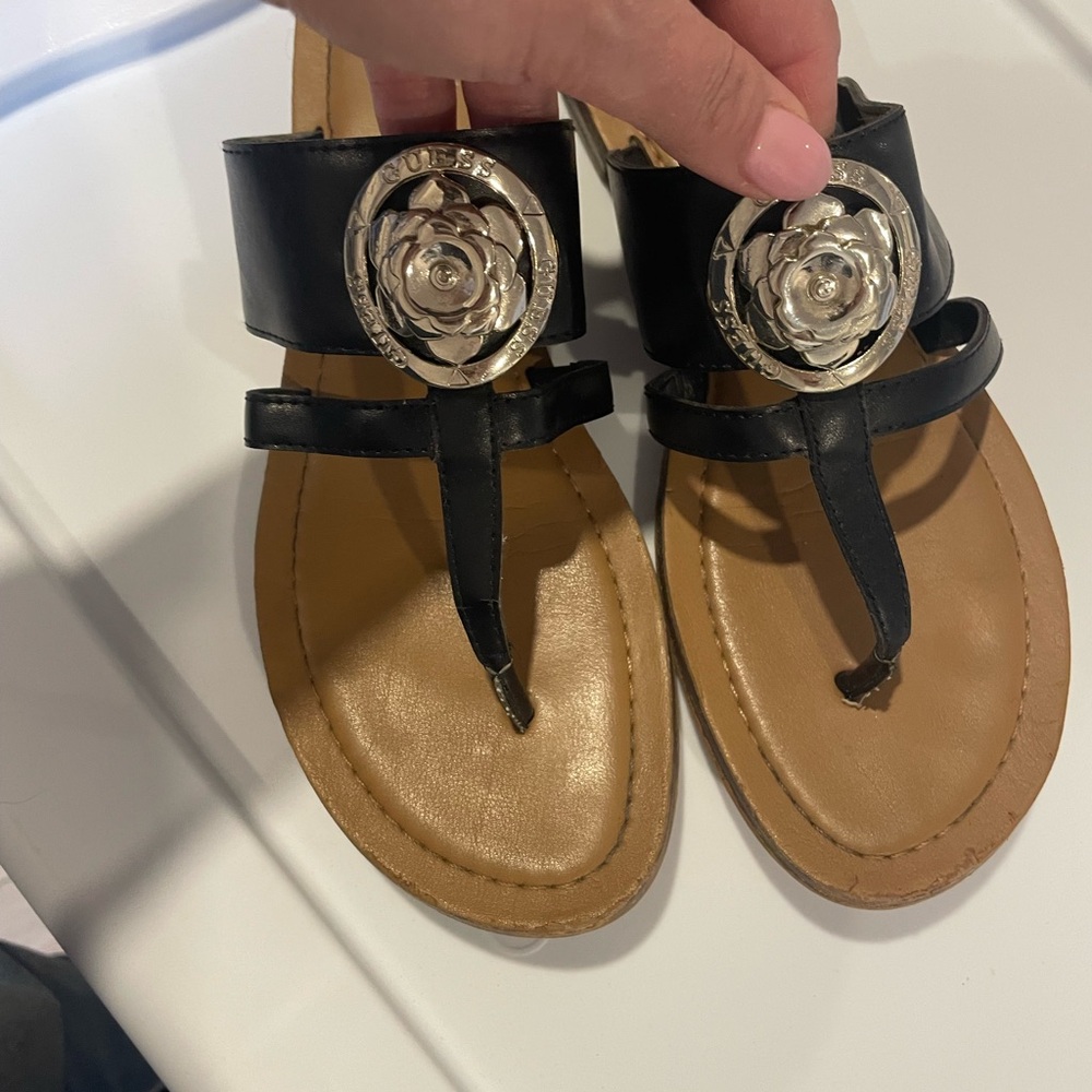 Guess Black Leather T-Strap Sandals with Silver Flower Emblems